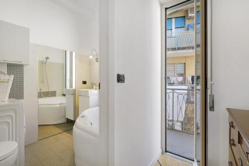 a white bathroom with a toilet and a sink at Beautifulliguria in Sestri Levante