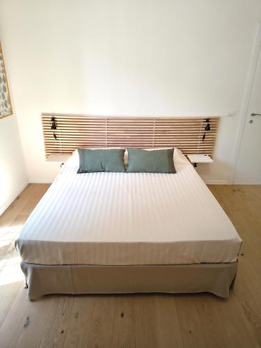 a large white bed in a room with a window at B&B La stanza del sole in Modena