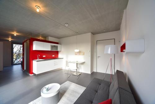 a living room with a couch and a red cabinet at Loft Apartments in Schorndorf