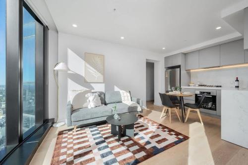 a living room with a couch and a table at LaneStay - 2BR Panoramic Views w Pool Spa & Gym in Melbourne