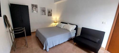 a small bedroom with a bed and a chair at Dimora Carucci in Noci