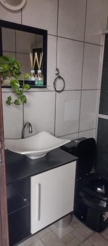 a bathroom with a sink and a toilet at Cakau House - espaço amplo e aconchegante in Maricá
