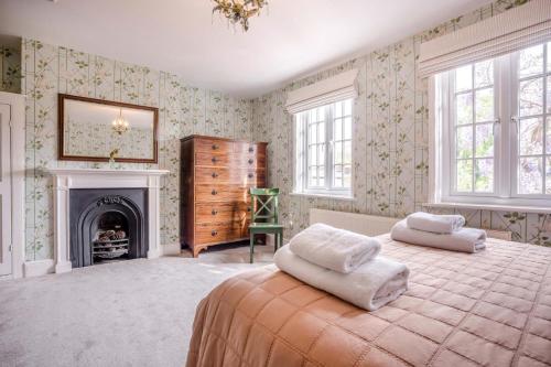 a bedroom with a large bed and a fireplace at 4 Bed in Lyndhurst oc-nfl57 in Lyndhurst