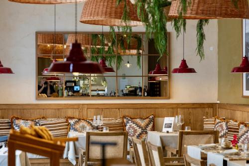 a restaurant with tables and chairs and pendant lights at Marvão Hotel Museu in Marvão