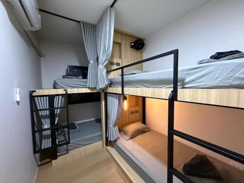a room with three bunk beds in a room at Jupiter Hostel in Ban Khlong Haeng
