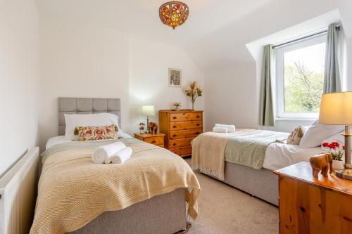 a bedroom with two beds and a window at 3 Bed in Dingwall oc-m39032 in Dingwall