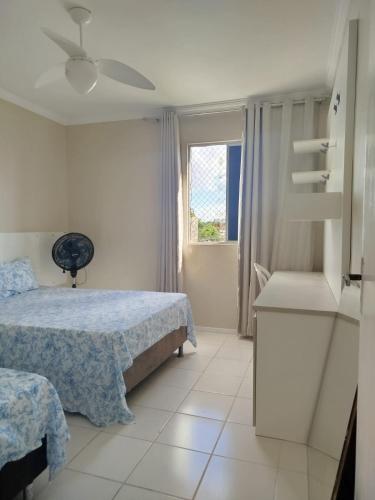 a bedroom with two beds and a window at Apto Amplo 3 quartos com lazer e bem localizado in Aracaju
