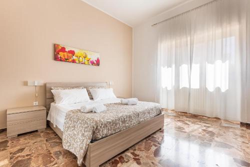 a bedroom with a bed and a large window at Salento Inside in Morciano di Leuca