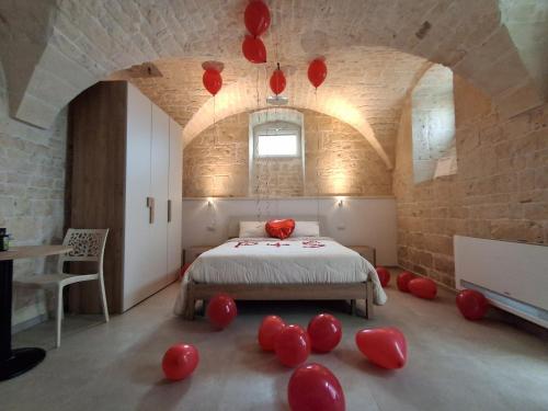 a bedroom with a bed with red balloons on the floor at b&b Olio su Pietra in Castellana Grotte