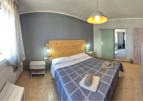 a bedroom with a large bed and a mirror at Relais La Terrazza in Palmadula