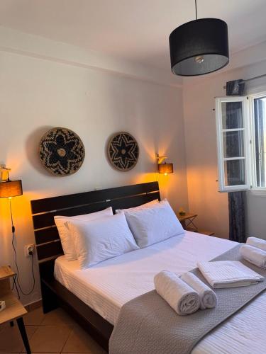 a bedroom with a large bed with towels on it at SeaBreeze Milos in Mytakas