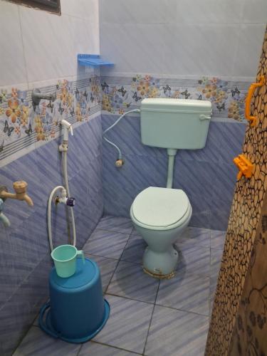 a bathroom with a toilet and a shower at Bhavadesh Lodge in Virudunagar
