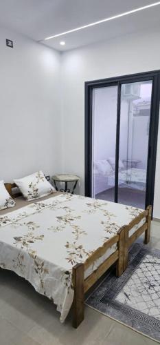 a large bed in a room with a window at Maison salakta in Ksour Essaf