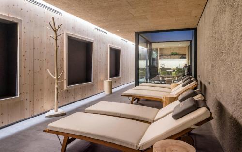 a row of chairs in a room with windows at Hotel Lener in Vipiteno