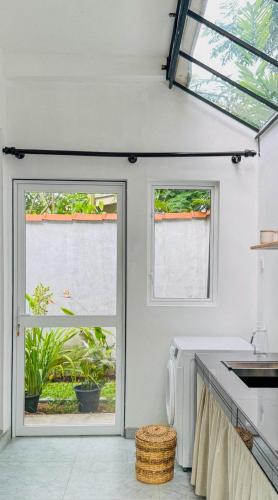 a kitchen with two windows and a sink at Hideaway in Bentota