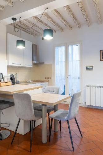a kitchen with a wooden table and chairs at Rjgal Apartment B&B - Private Courtyard Florence Center in Florence