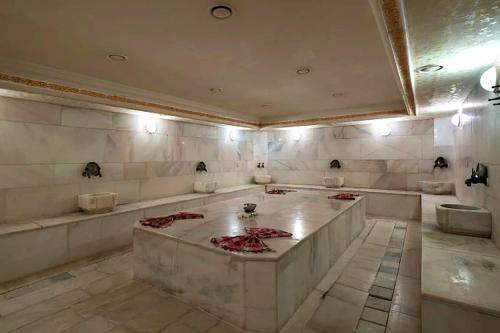 a large bathroom with three sinks and two toilets at Çamyuva Luna Hotel in Kemer