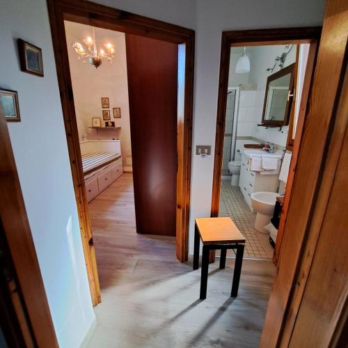a bathroom with a toilet and a stool in the hallway at Il Conte di Montechiaro Rural B&B in Sasso Marconi