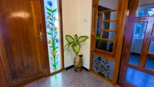 a room with a door and a vase next to a door at Cloud Crest Homestay in Ooty