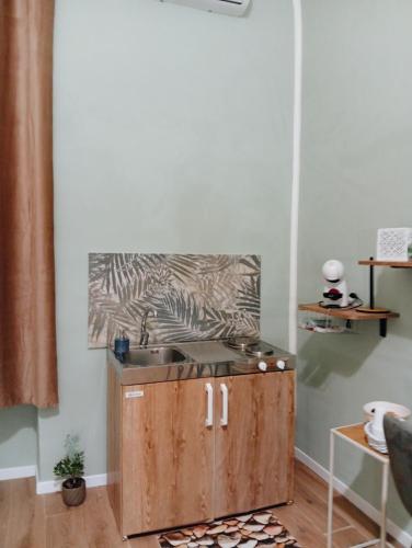 a kitchen with a sink and a zebra painting on the wall at Le Suite di Antonella in Taranto