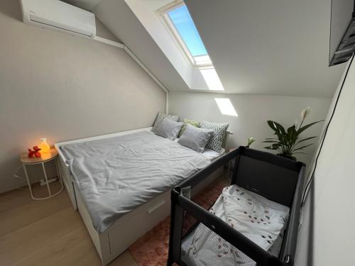a small bedroom with a bed and a window at Main Square Olive Studio in Trnava