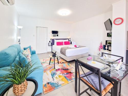 a living room with a bed and a blue couch at Apartments Edifício Cruzeiro in Portimão