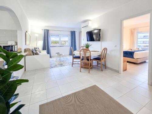 a living room with a table and a bedroom at Apartment Praia Rocha River-Sea in Portimão