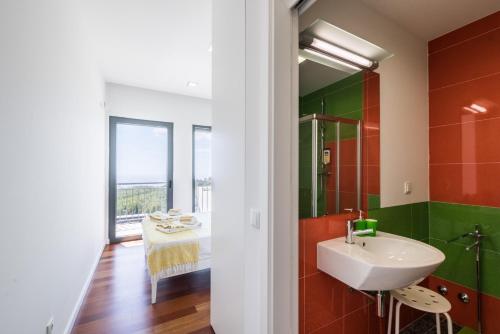 a bathroom with a sink and a mirror at Villa Monchique in Monchique