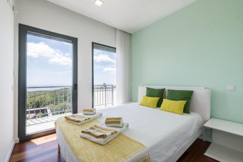 a bedroom with a bed with a large window at Villa Monchique in Monchique