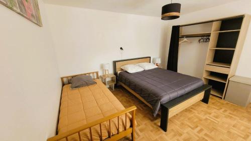 a bedroom with two beds and a book shelf at Gîte Champgrand in Loriol-sur-Drôme