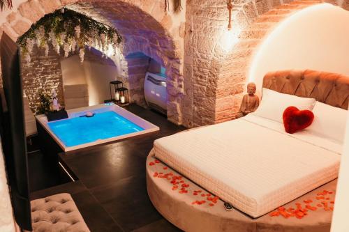 a bedroom with a bed and a swimming pool at Moira Suite in Bitonto