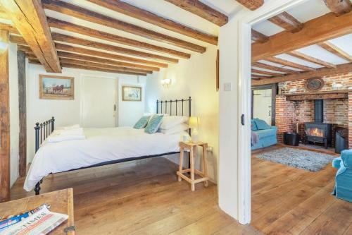 a bedroom with a bed and a fireplace at 3 Bed in Southwold oc-hsmugg in Southwold
