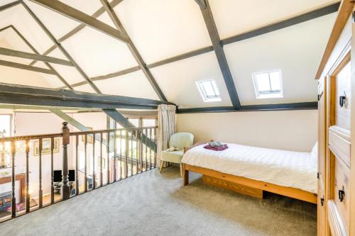 a bedroom with a bed and a balcony at 3 Bed in Little Ellingham oc-2147 in Rockland Saint Peter