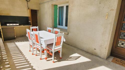 a white table and chairs on a patio at Gîte Champgrand in Loriol-sur-Drôme
