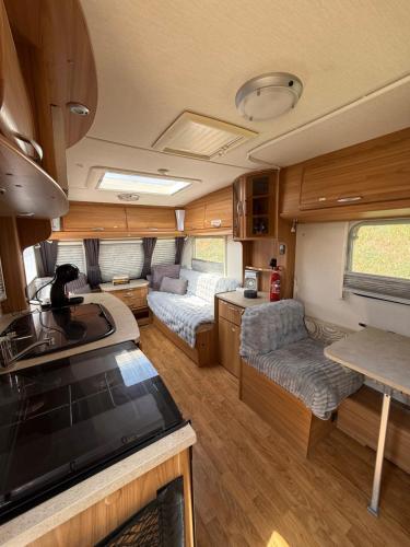 a kitchen and living room of an rv at Little Hideaway Deluxe in Costa da Caparica