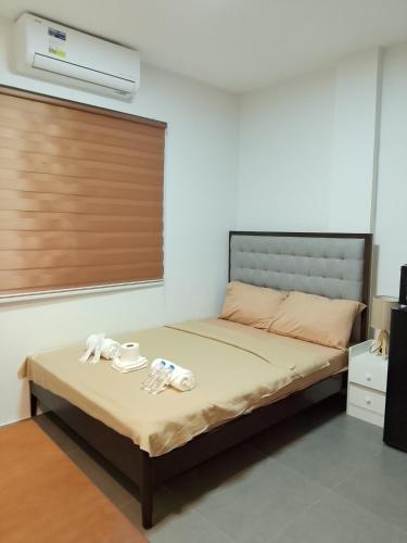 a bedroom with a bed with two towels on it at Axc cozy inn in Olongapo