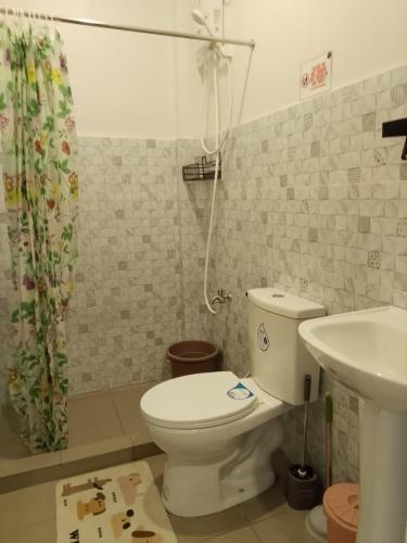 a bathroom with a toilet and a sink at Axc cozy inn in Olongapo