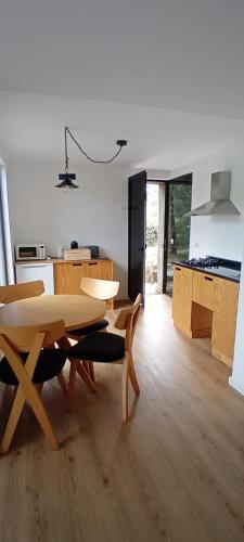 a kitchen and dining room with a table and chairs at Ninho da Avó Selvagem in Montalegre