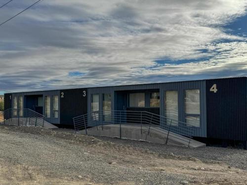a black building with the number four on it at Simple Aparts in El Calafate