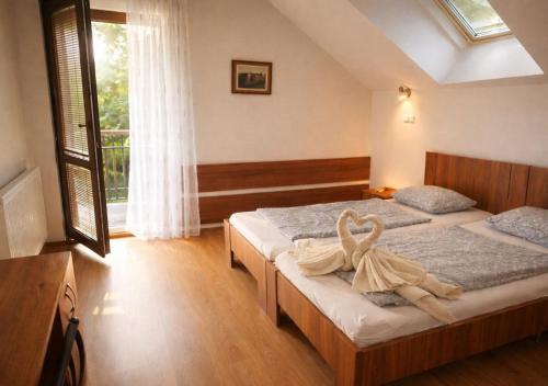 a bedroom with two beds and a large window at Ekofarma Sádky in Uherské Hradiště