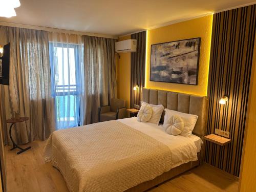a bedroom with a bed and a yellow wall at Formula 1 Motel in Byala Ruse