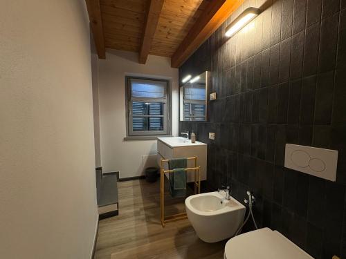 a bathroom with a white toilet and a sink at Dimora Federica in Erbusco