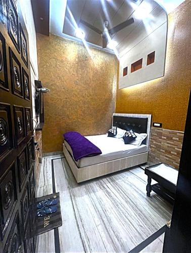 a room with a bed and a table in it at HOTEL Gumber in Sirsa
