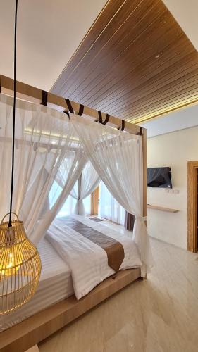 a large bed with a canopy in a bedroom at Kamaya Villa Jogja in Ngaglik