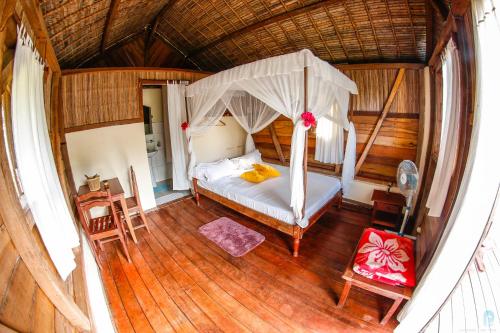 an aerial view of a bedroom with a canopy bed at Antafondro Lodge in Sainte Marie