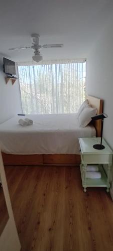 a bedroom with a large bed and a window at Ninho da Avó Selvagem in Montalegre