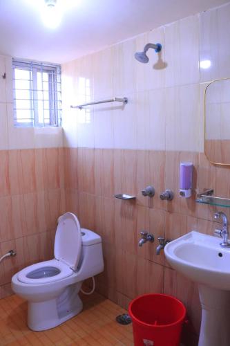 a bathroom with a toilet and a sink at Epindi Studio Apartment in Cox's Bazar
