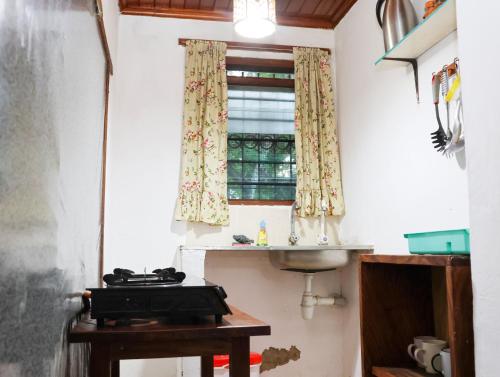 a kitchen with a sink and a window at Tradewinds Lodge in Diani Beach