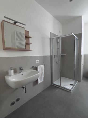 a bathroom with a sink and a shower at ApparTea in Marostica