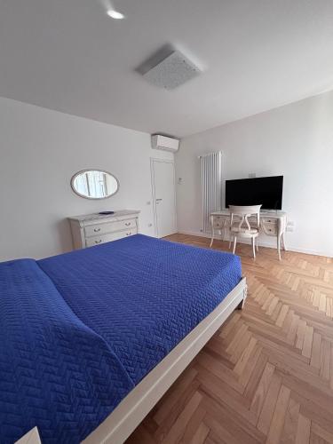 a bedroom with a blue bed and a table and chairs at ApparTea in Marostica